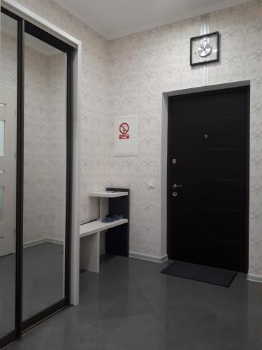 a black door in a room with a desk at IRIS apartments in Odesa