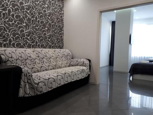 a living room with a couch and a wall at IRIS apartments in Odesa