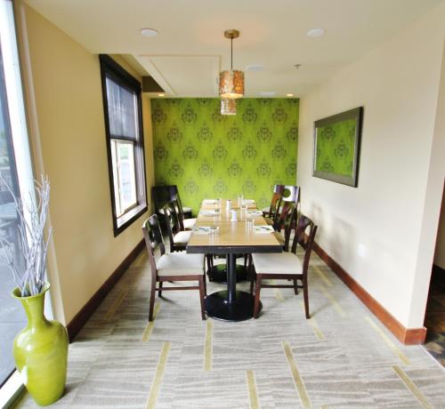 a dining room with a table and chairs and a vase at Silver Creek Lodge in Canmore