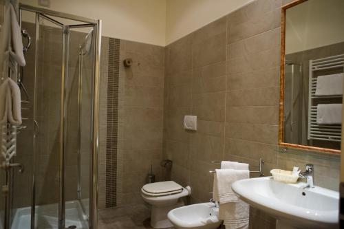a bathroom with a toilet and a sink and a shower at B&B Suite Paciotti in Trani
