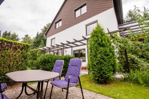 a table and chairs in front of a house at Haus Fernblick in Bad Grund
