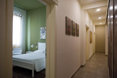 a bedroom with a bed and a hallway at B&B Suite Paciotti in Trani