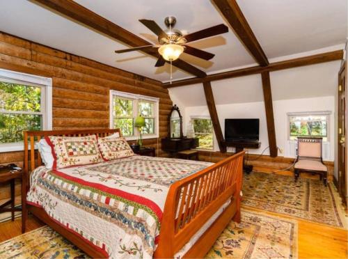 a bedroom with a bed and a ceiling fan at Eagle's Rest Lodge in Hendersonville