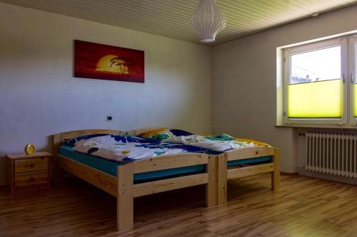 a bedroom with a wooden bed in a room at Apartment Bellevue in Blieskastel