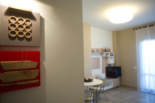 a living room with a table and a red cabinet at Le Dimore Del Re in Trani