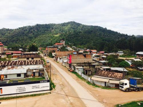 a small village with a road in front of a mountain at Hostal Oro Verde-Villa Rica in Villa Rica