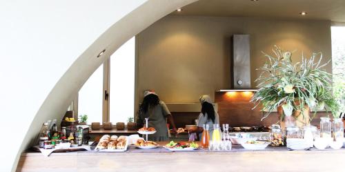 two women standing in a kitchen with food on a table at Mosselberg on Grotto Beach in Hermanus