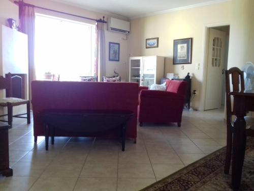 a living room with a couch and a table at Blue Sky appartment in Pallíni