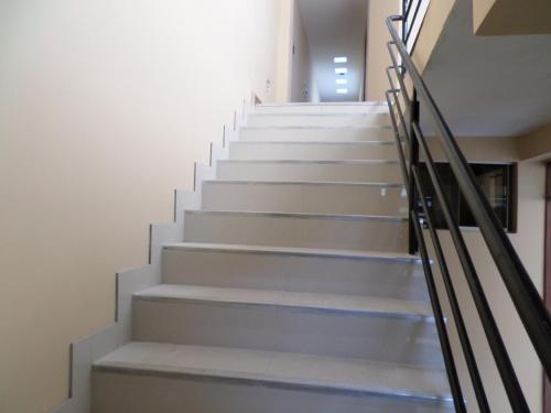 a staircase in a building with white steps at D' Barrig in Trujillo