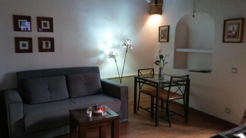 a living room with a couch and a table at Casa Campon in Utrera
