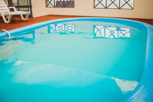 a swimming pool with blue water in a room at JOH Blue Ocean Flat Hotel in Fortaleza