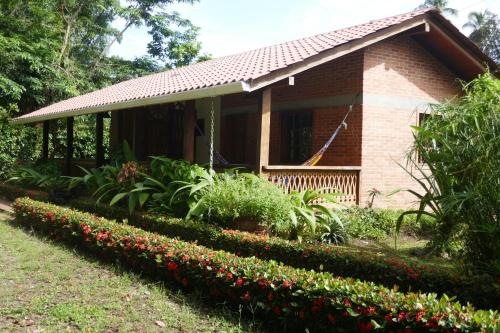 a small house with flowers in front of it at Escape Caribeño in Puerto Viejo