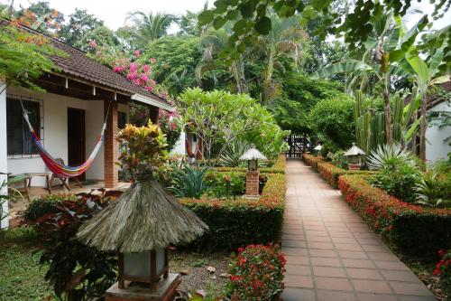 a walkway in a garden with flowers and plants at Escape Caribeño in Puerto Viejo