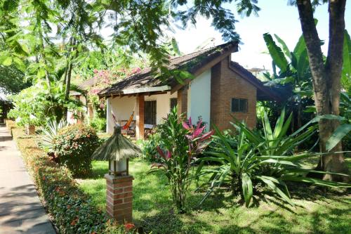 a small house in the middle of a garden at Escape Caribeño in Puerto Viejo