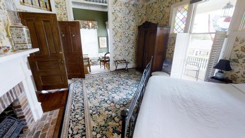 a bedroom with a bed in a room with wallpaper at Hanna House Bed & Breakfast in New Bern