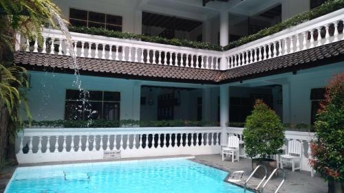 a swimming pool in the courtyard of a house at Bladok Hotel & Restaurant in Yogyakarta