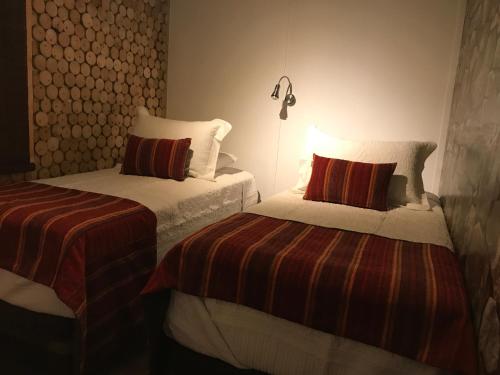 Postel nebo postele na pokoji v ubytování Hotel Manada del Desierto