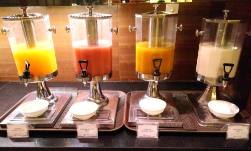 a display of different colored drinks in glass jars at Ming Garden Hotel & Residences in Kota Kinabalu