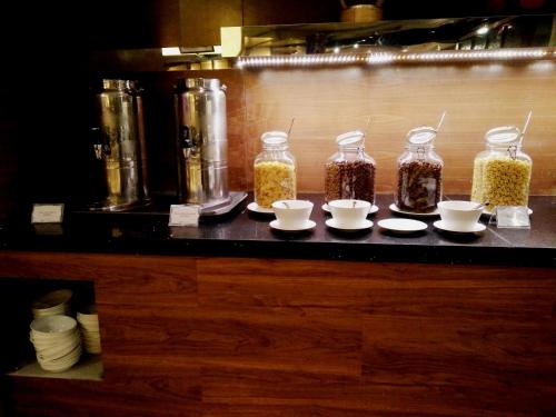 a counter with jars of spices and bowls of food at Ming Garden Hotel & Residences in Kota Kinabalu