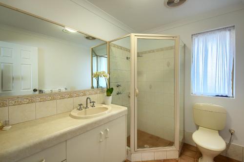 a bathroom with a toilet and a sink and a shower at Pelicans Albany Middleton Beach in Albany