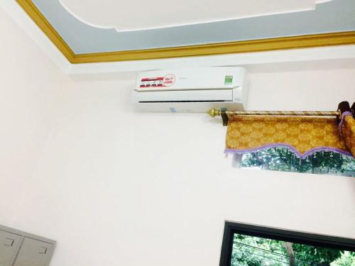 a towel hanging on a wall next to a window at Ngan Ha Homestay in Ha Giang