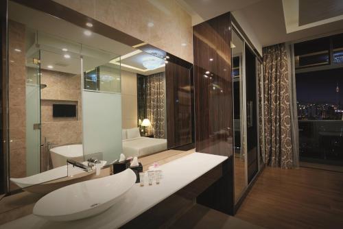 a bathroom with a sink and a bath tub at Dorsett Residences Bukit Bintang @Dorsett Kuala Lumpur in Kuala Lumpur