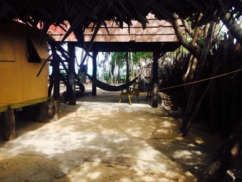 a room with a hammock in a building at Beach Hut in Arugam Bay