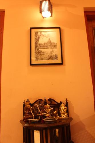 a table in a room with a picture on the wall at Udai Niwas - Bikaner in Bikaner
