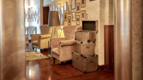 a room with a stack of suitcases in a living room at Grand Hotel Stamary in Zakopane
