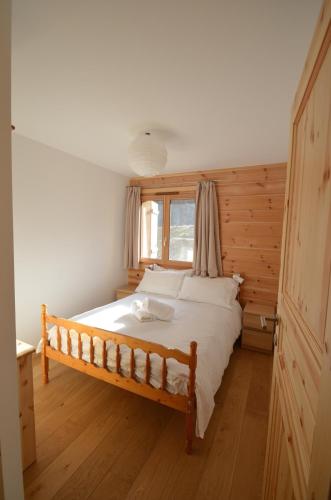 a bedroom with a large bed with a window at Le Nid de Martinet in Grimentz