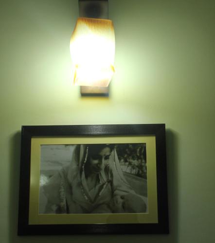 a picture of a woman on a wall with a lamp at Udai Niwas - Bikaner in Bikaner