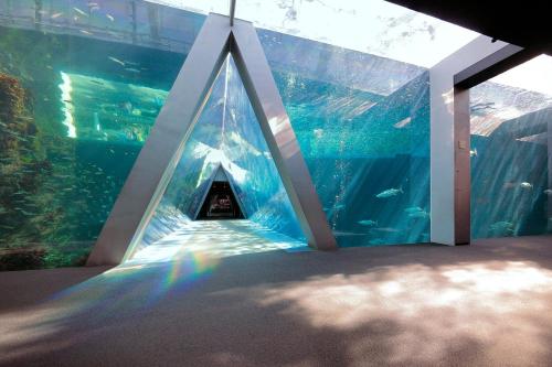 a tunnel in an aquarium with fish in it at Hotel Crown Hills Iwaki in Iwaki