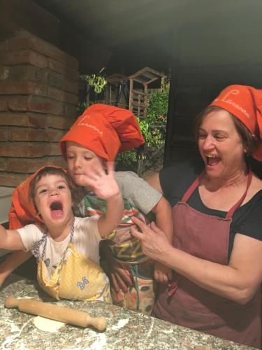 two women and a child are laughing and screaming at Podere Casanova in Montespertoli