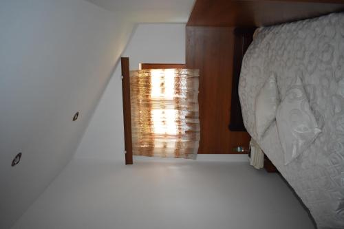 a bedroom with a lamp next to a bed at Complex Oazis in Etropole