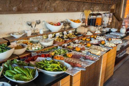 a buffet line with many different types of food at Kapadokya Hill Hotel & Spa (12+) in Nevsehir