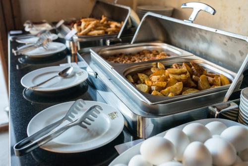 a buffet with plates of food and eggs on a table at Kapadokya Hill Hotel & Spa (12+) in Nevsehir