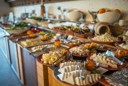 a buffet line with many different types of food at Kapadokya Hill Hotel & Spa (12+) in Nevsehir