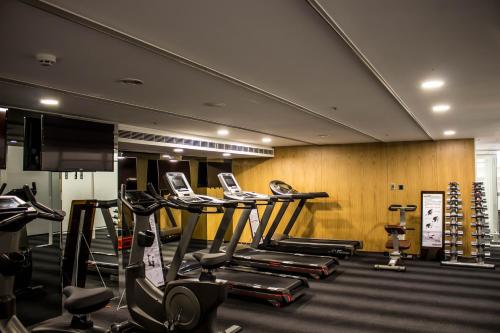 a gym with several treadmills and elliptical machines at The Carlton Taichung in Taichung