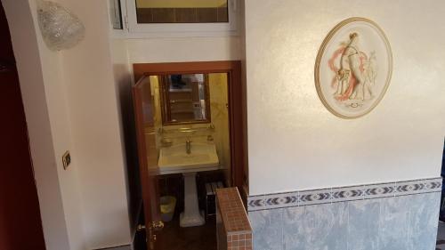a bathroom with a sink and a mirror at Motel Villaggio in Imola