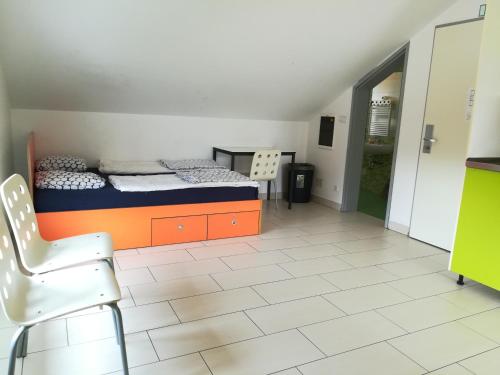 a room with a bed and a chair in it at Simbol Rooms with free private parking in Ljubljana