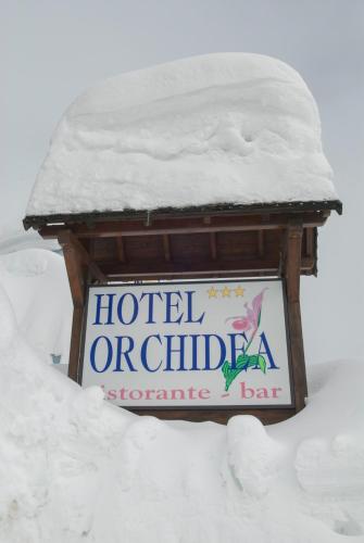 a sign for a hotel orilla in the snow at Hotel Orchidea in Passo del Tonale