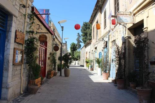 an alley in an old town with potted plants at Artemis Boutique Apartment 1 in Limassol