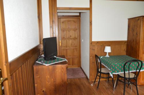 a room with a table and a tv and a table and chairs at Willa Janosik in Witów