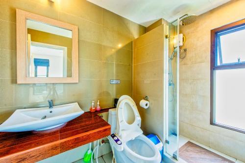 a bathroom with a toilet and a sink and a shower at Tree Boutique Residence - Quiet Oasis - Stunning View, Pool & Gym in Chiang Mai