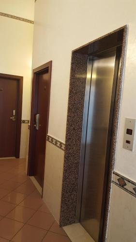 a hallway with a stainless steel refrigerator in a building at Motel Villaggio in Imola