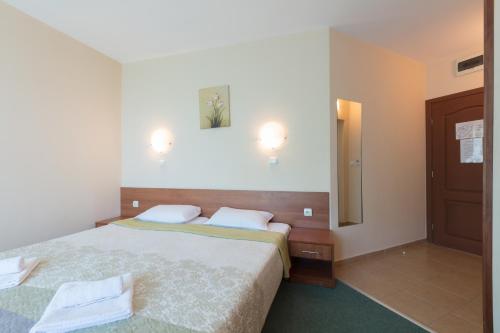 a hotel room with a bed and a mirror at Hotel L&B- Free parking in Sunny Beach