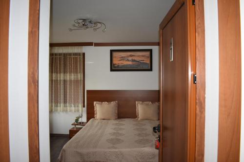 a bedroom with a bed and a door to a room at Complex Oazis in Etropole