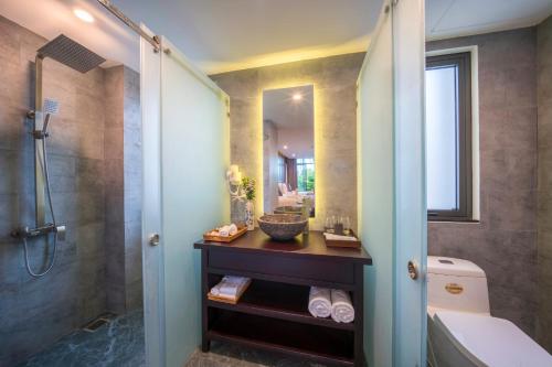 a bathroom with a shower and a sink and a toilet at Dai An Phu Villa in Hoi An