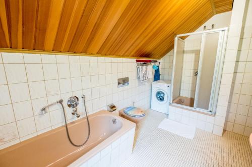a bathroom with a tub and a toilet in it at Haus Fernblick in Bad Grund