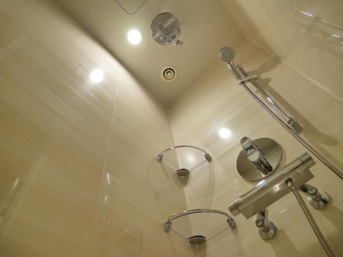 a bathroom with a shower with a glass door at Red Roof Inn & Suites Osaka Namba Nipponbashi in Osaka